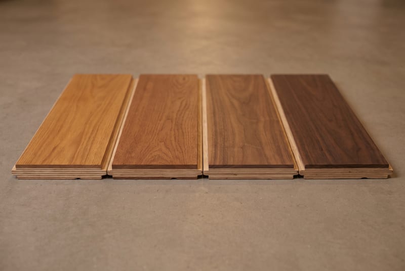 Engineered hardwood plank samples from warm oak through deeper walnut.